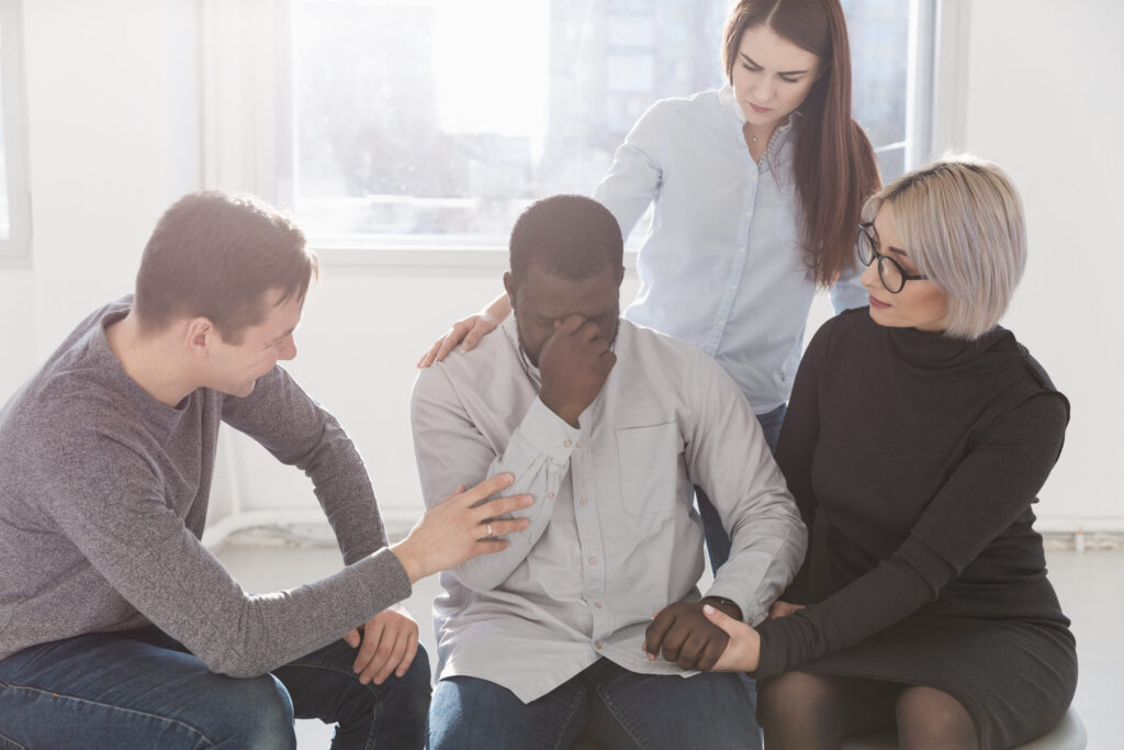 group of friends encouraging friend with their mental health problem